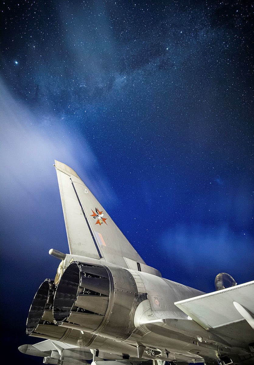 Aircraft tail under the blue stars of space.